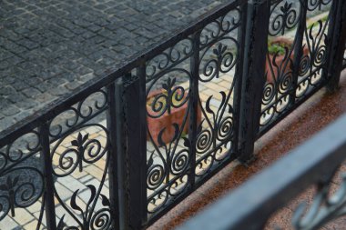 Şehirde metal korkuluklara düşen yağmur damlaları.