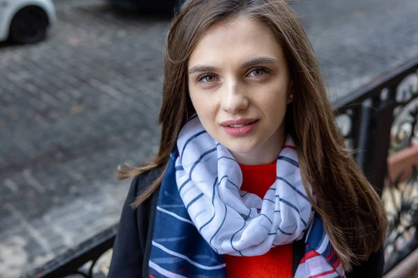 Young woman on a city street. Close-up portrait