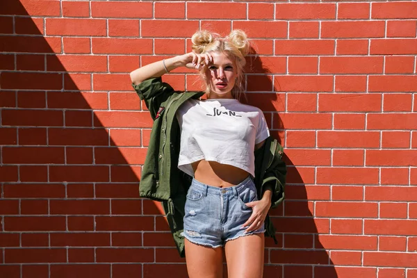 Woman standing against brick wall