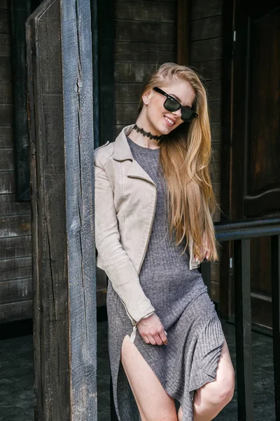 Modelo em óculos de sol posando perto da casa — Fotografia de Stock