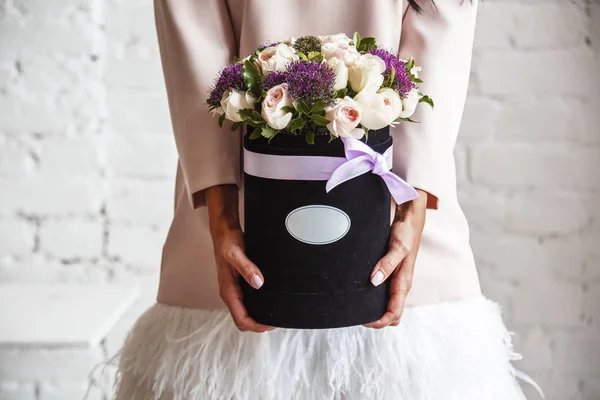 Woman holding  flowers in a basket