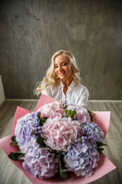 blonde  woman with hydrangea bouquet