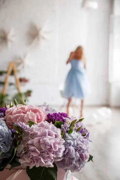 hydrangea bouquet and woman in blue dress