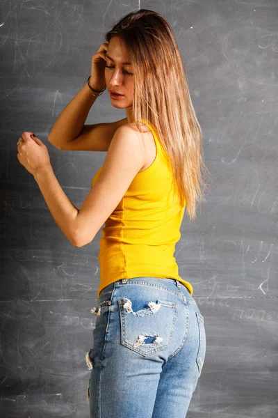 Schöne Junge Frau Gelbem Shirt Und Blauer Jeans Vor Tafel — Stockfoto