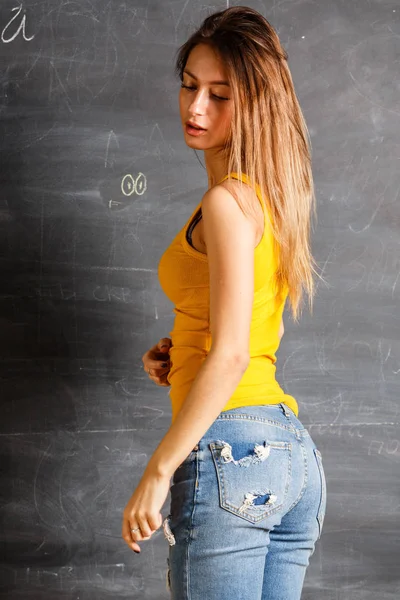 Beautiful Young Woman Wearing Yellow Shirt Blue Jeans Standing Blackboard — Stock Photo, Image