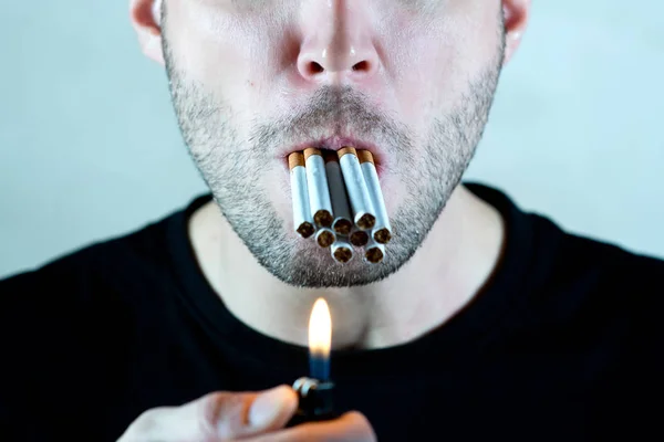 The mouth of an unshaven man and a lot of cigarettes in it — Stock Photo, Image