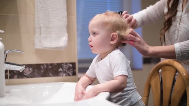 Mam Kamt Het Haar Van Haar Dochtertje Voor Badkamerspiegel Focus — Stockvideo