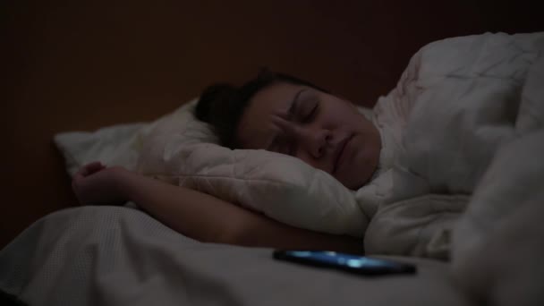 Night Girl Disturbed Phone She Switches Silent Mode Continues Sleep — Stockvideo