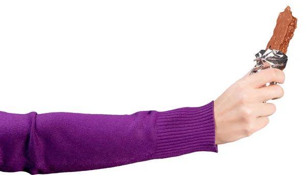 Die weibliche Hand in einem knallvioletten Sweatshirt hält eine geöffnete Schokoriegel in der Hand. isoliert — Stockfoto