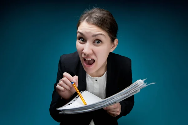 Strict female boss screaming, poking a pen into documents on a blue background