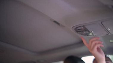 Kız arabanın kapağını açmak için düğmeye basar ve kapak açılır.