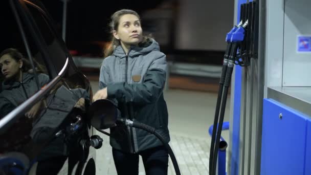 Mädchen betankt ihr Auto mit Diesel und schließt den Gastank — Stockvideo