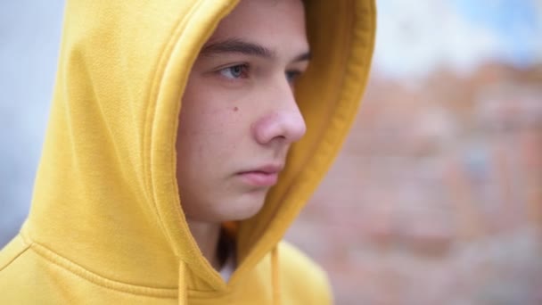 Teenager Yellow Sweatshirt Looks Front Him Close — Stock Video