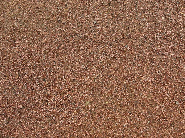 ベージュの石の砂利の背景のテクスチャ 茶色の小さな岩抽象的な道路舗装パターン — ストック写真