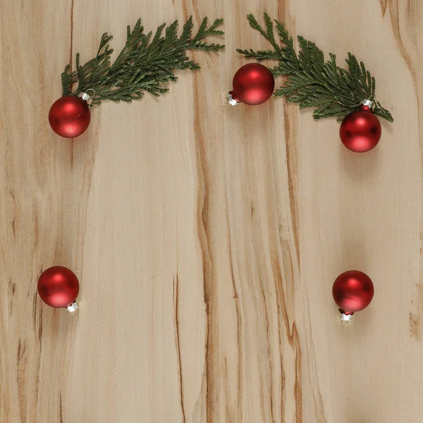 Shiny glowing baubles on a flat wooden background. Glimmering, shimmering winter christmas background. Space for advertising products, decorations and text.