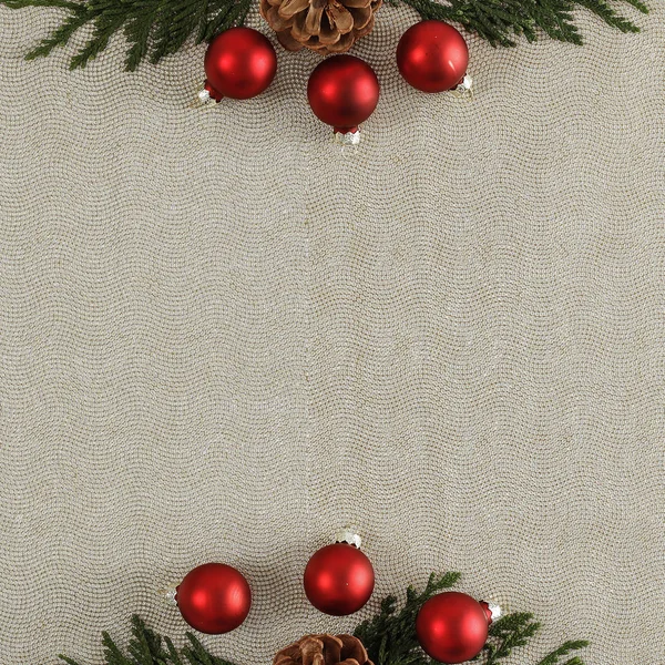 Shiny glowing small baubles on a flat texture background. Christmas decoration seen from above. Glimmering, shimmering winter christmas background. Space for advertising products, decorations and text.