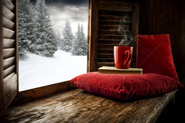 Wooden old window with empty space for your products. Brown old window frame and window sill. Winter view outside the window with snow and frost.Copy space. Snowy forest outside the window.