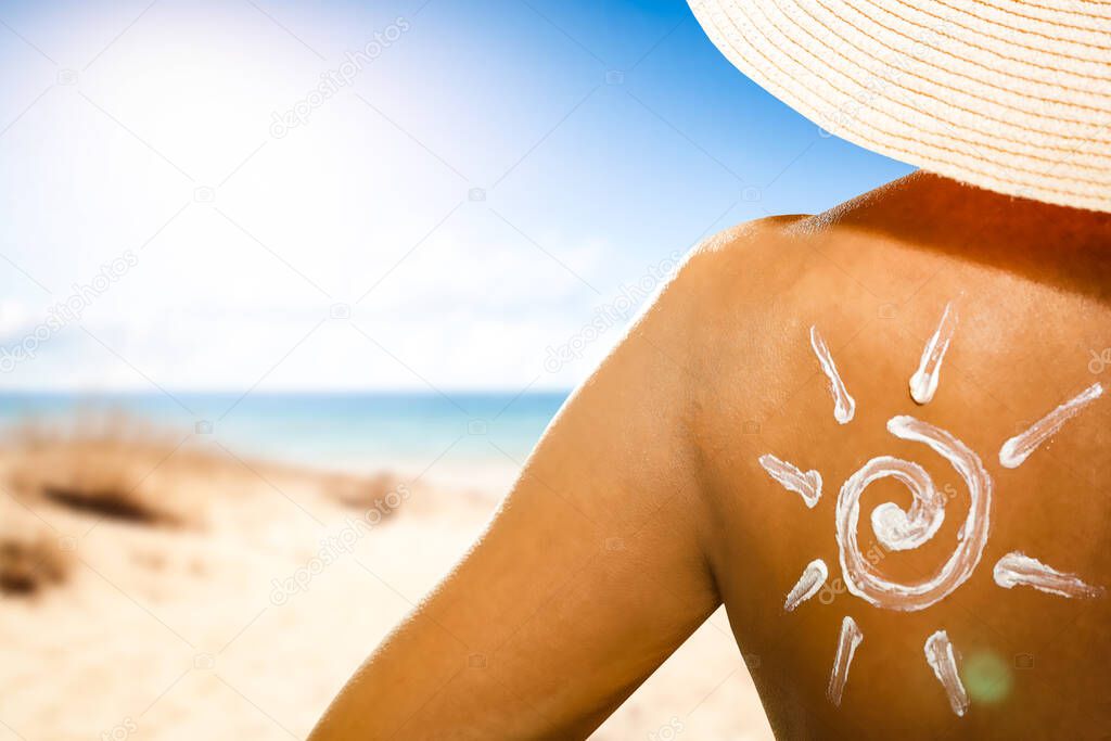 Woman with sun cream on her back and summer beach background. Space for your decoration or product. 