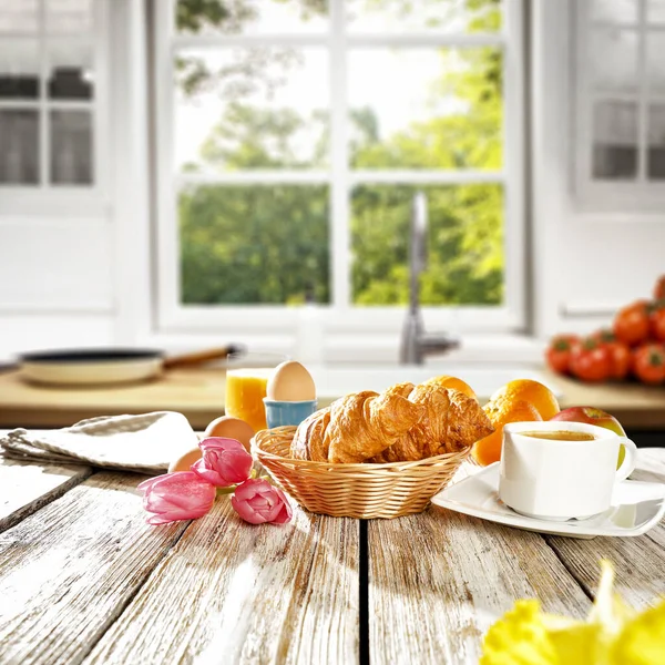 Kitchen table and breakfast in the morning sunshine window background. Easter time. Blurred background of window space.