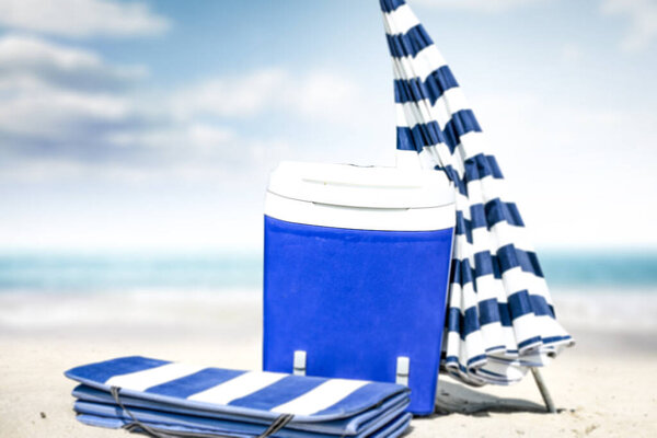 Summer photo of beach and blue beach fridge with umbrella. Sunny day and ocean landscape. 