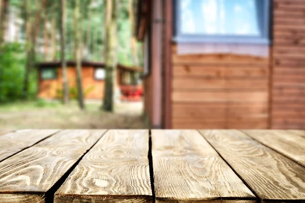 Wooden table with space for products and decorations. Camping time in the wood. Holiday summer house andoutdoor recreation.