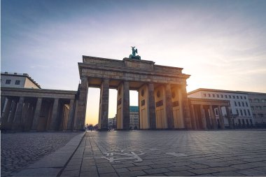 Brandenburg gate illuminated at sunset