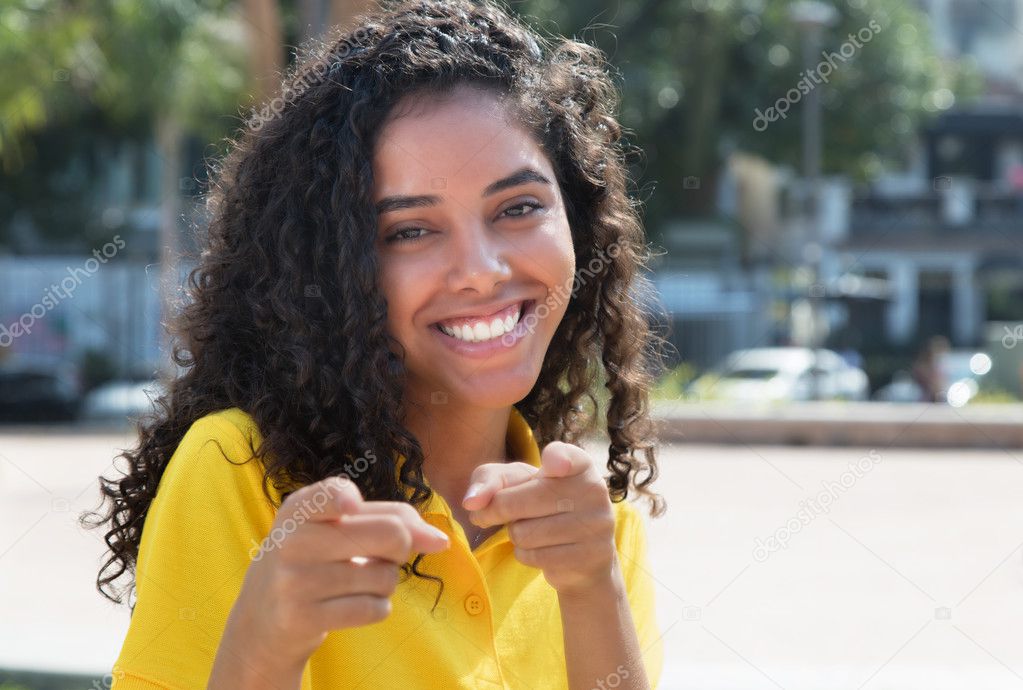 Pointing latin american girl with long dark hair