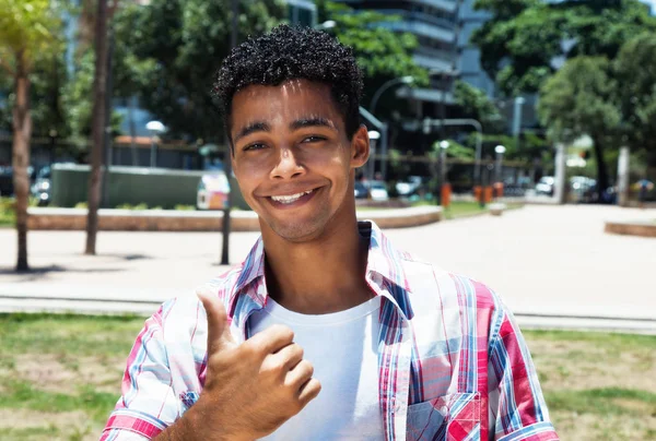 Happy latin young adult showing thumb up — Stock Photo, Image