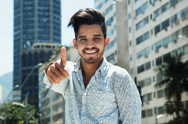 Handsome hipster with beard Showing thumb in the city — Stock Photo, Image