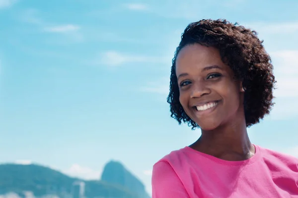 Cheerful woman at Rio with blue sky and copy space — Stock Photo, Image