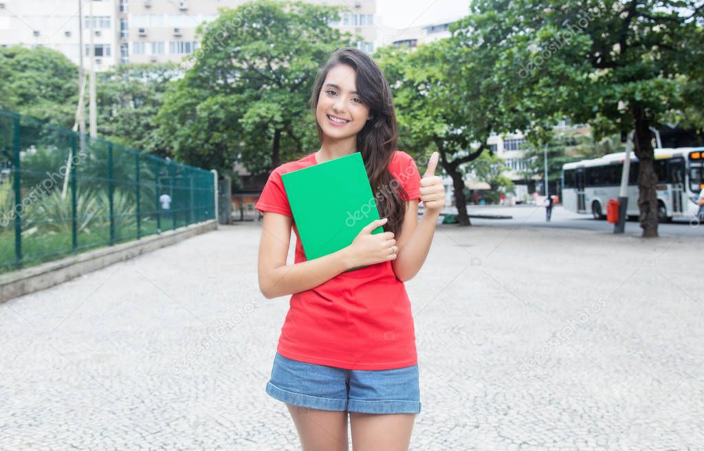 Young caucasian female student with red shirt in the city