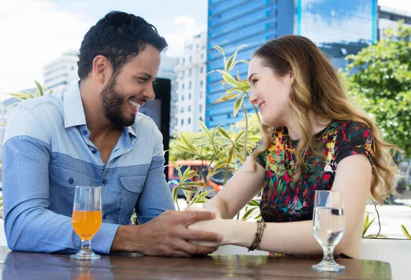 Caucasian love couple holding hands in a restaurant outdoor in t