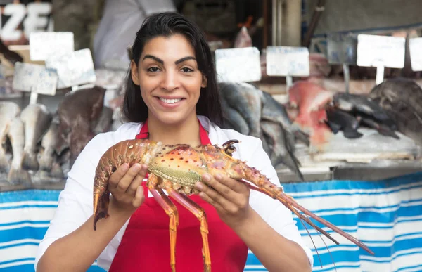 Beautiful woman selling seafood on a latin fish market — Stock Photo, Image