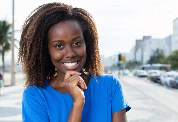 Mulher americana africana bonita em uma camisa azul — Fotografia de Stock