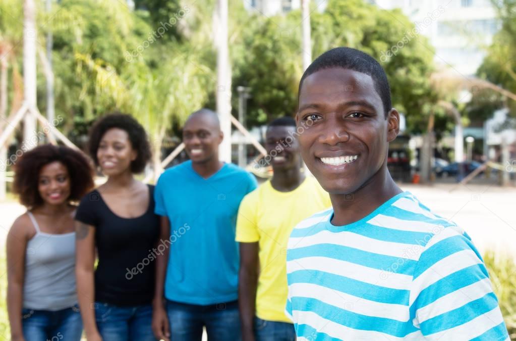 Laughing african american man with group of people from Africa