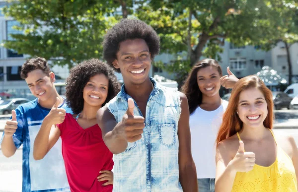 Laughing african guy with group of caucasian and latin american — Stock Photo, Image