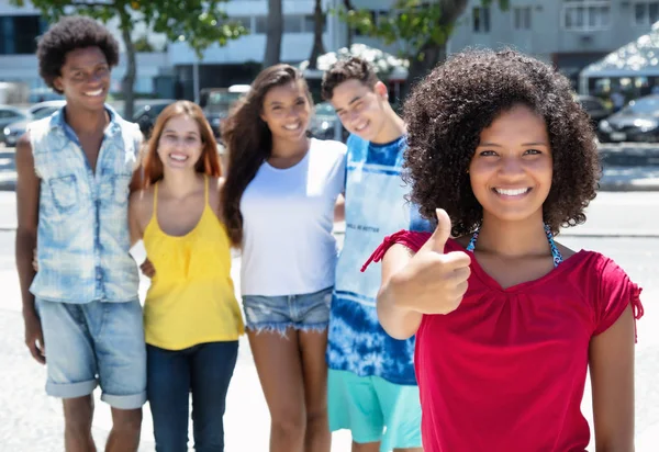 African american girl showing thumb with group multi ethnic peop — Stock Photo, Image