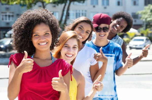 Group of multicultural young adults in a row — Stock Photo, Image