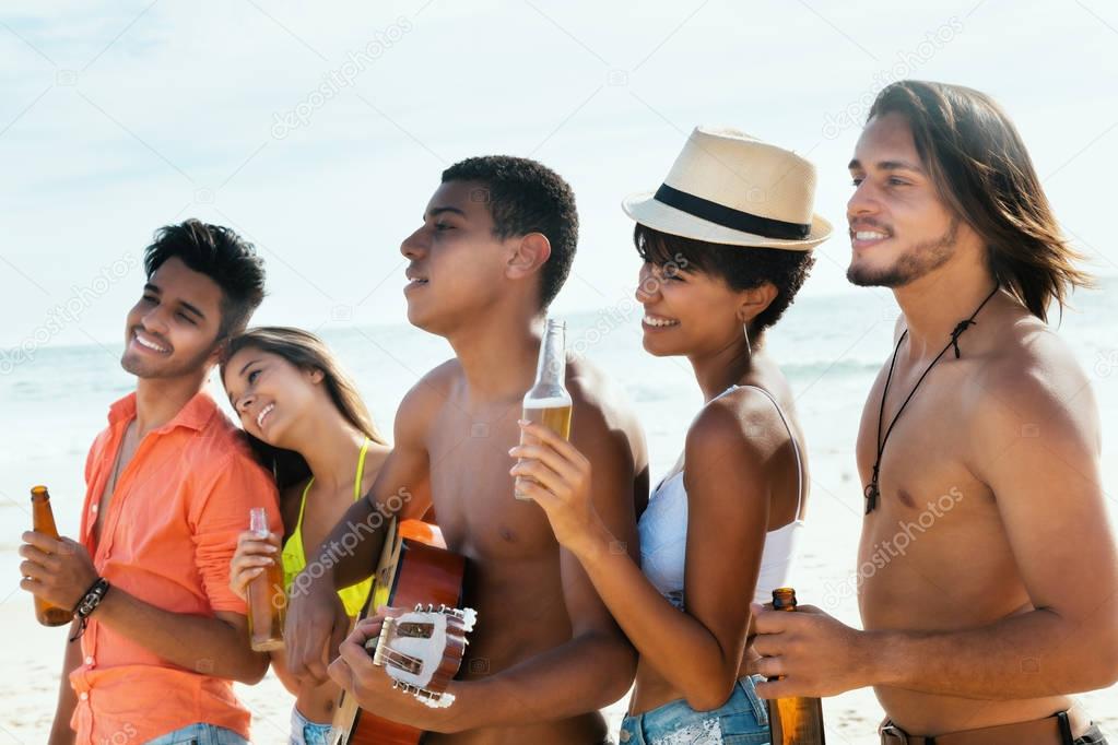 Group of young adults enjoys life at beach