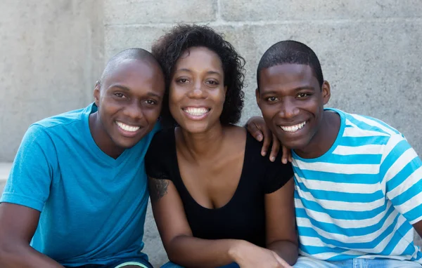 Three african american men and woman looking at camera — Stock Photo, Image