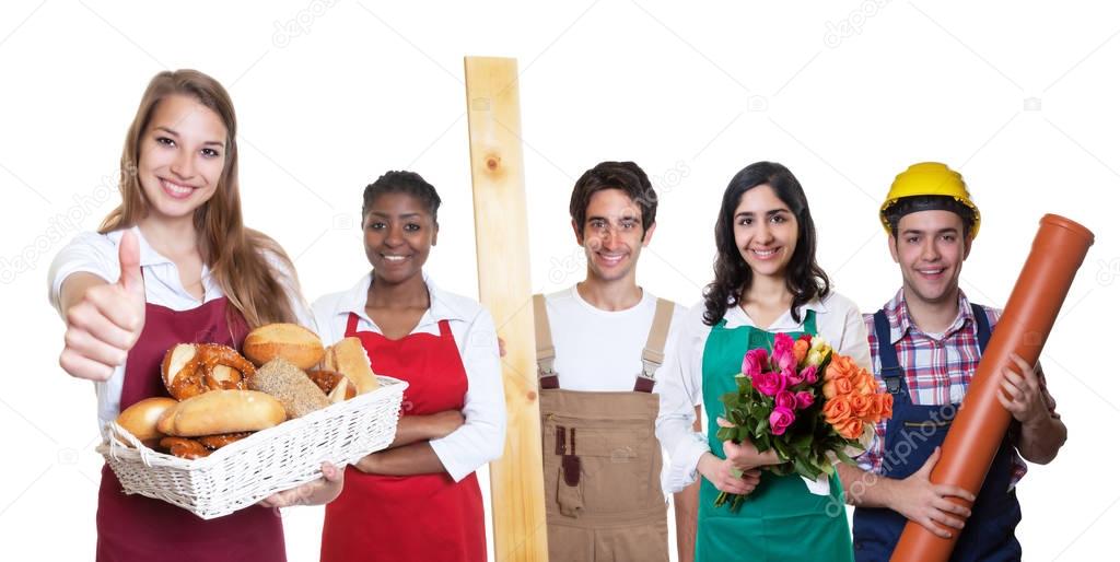 Laughing caucasian female baker with group of other internationa