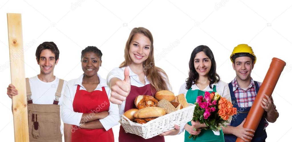 Successful caucasian female baker with group of other internatio