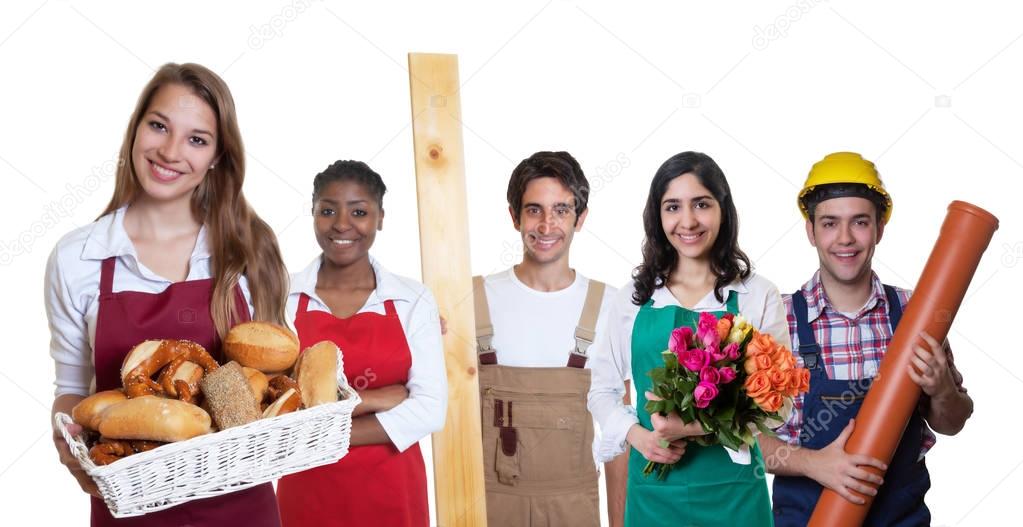 Happy caucasian female baker with group of other international a