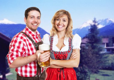 Happy bavarian man with leather pants and blonde woman with dirn clipart