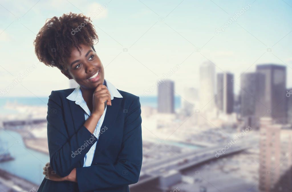Thinking african american businesswoman with skyline of city