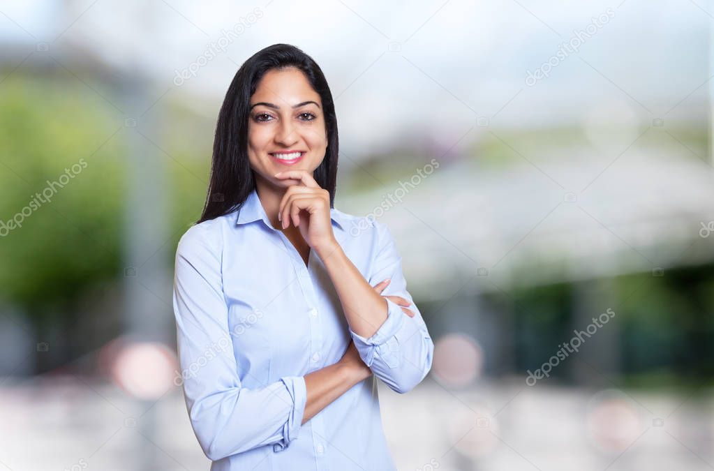 Laughing arabic businesswoman looking at camera