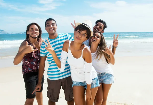 Grupo de jóvenes y jóvenes adultos bailando en la playa — Foto de Stock