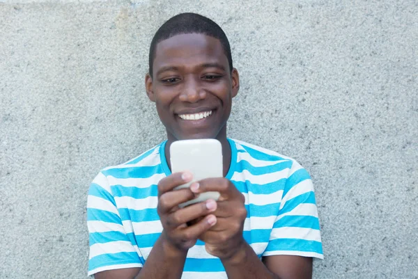 African american man sending text message