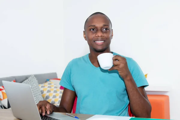 Adult african american man with laptop taking a break — Stock Photo, Image