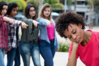 Group of girls bullying an african american woman clipart